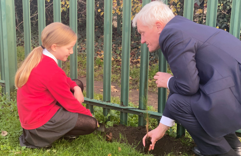 Graham planting a tree with their School Eco-Minister Angel