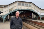 Graham stood in front of the bridge at Beverley train station